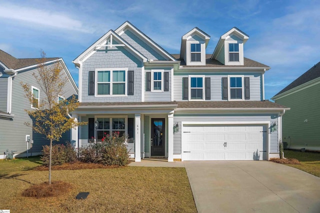 view of front of home with a garage and a front lawn