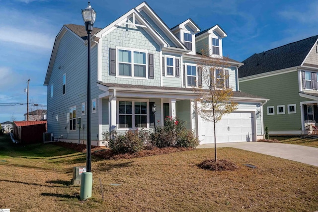 view of front of house with central AC unit, a garage, and a front lawn