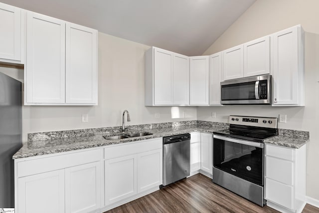 kitchen featuring white cabinetry, sink, dark hardwood / wood-style flooring, lofted ceiling, and appliances with stainless steel finishes