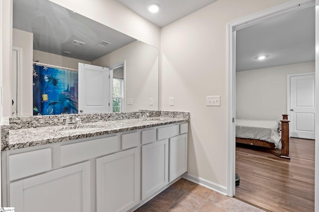 bathroom with vanity, hardwood / wood-style flooring, and walk in shower