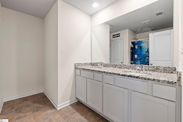 bathroom featuring vanity and curtained shower