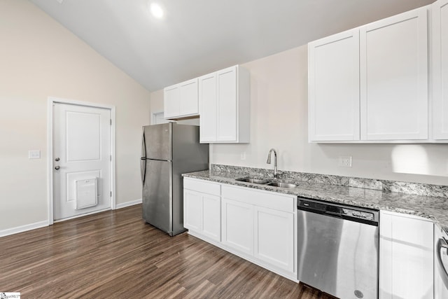 kitchen with sink, dark wood-type flooring, vaulted ceiling, white cabinets, and appliances with stainless steel finishes