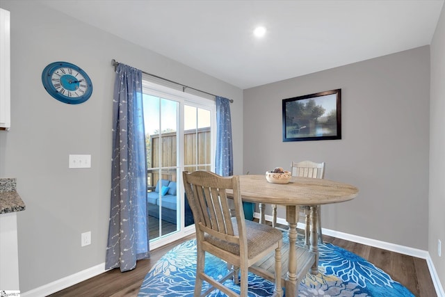 dining space with dark wood-type flooring