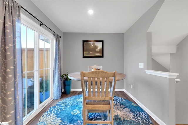 dining area with dark hardwood / wood-style flooring