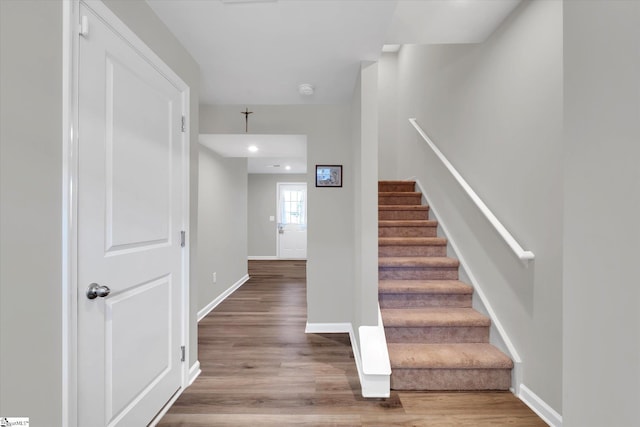 staircase with hardwood / wood-style flooring