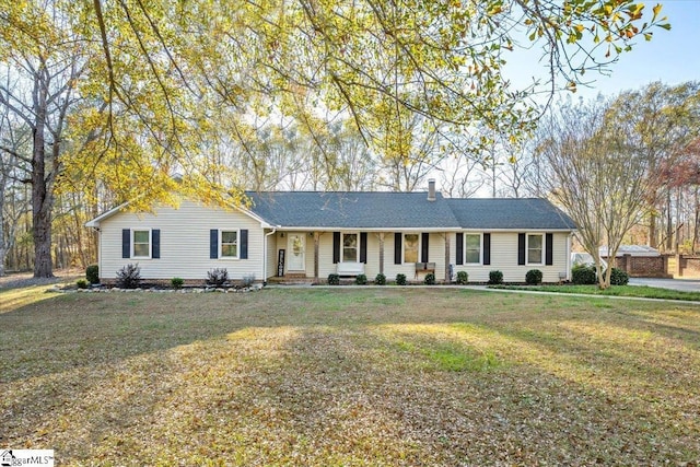 ranch-style house with covered porch and a front yard