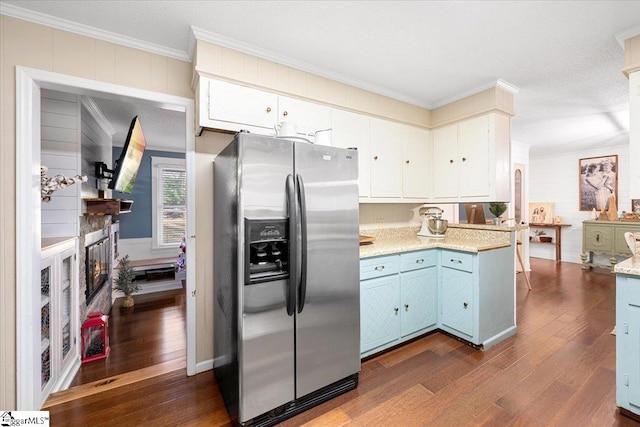 kitchen with white cabinets, stainless steel fridge, ornamental molding, and dark wood-type flooring