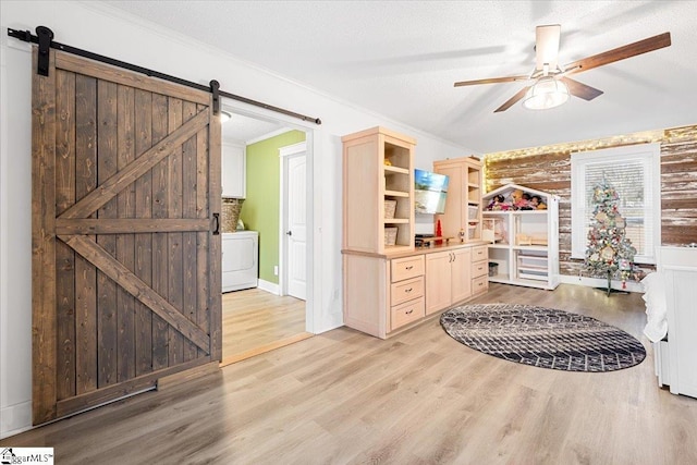 interior space featuring hardwood / wood-style floors, ceiling fan, ornamental molding, a textured ceiling, and washer / dryer