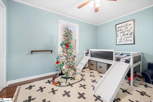 interior space with ceiling fan, crown molding, and wood-type flooring