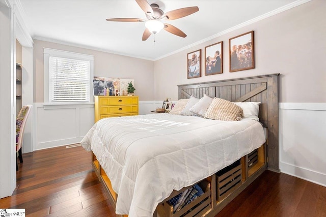 bedroom featuring ornamental molding, ceiling fan, and dark wood-type flooring