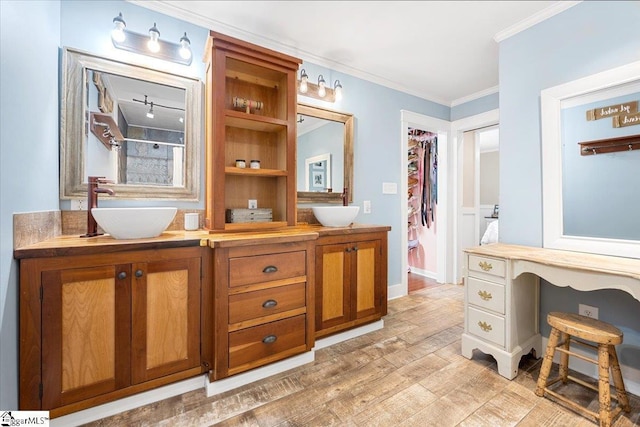 bathroom featuring a shower, vanity, hardwood / wood-style flooring, and crown molding