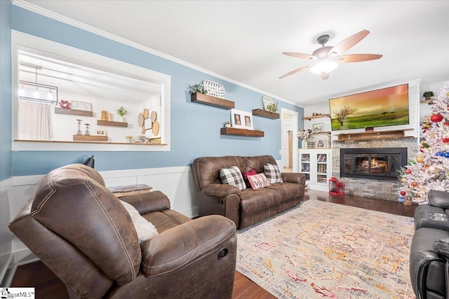 living room with hardwood / wood-style flooring, ceiling fan, and crown molding