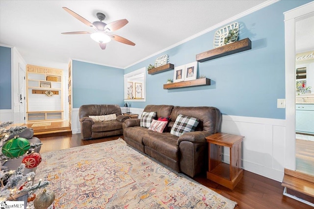 living room with dark hardwood / wood-style floors, ceiling fan, and crown molding