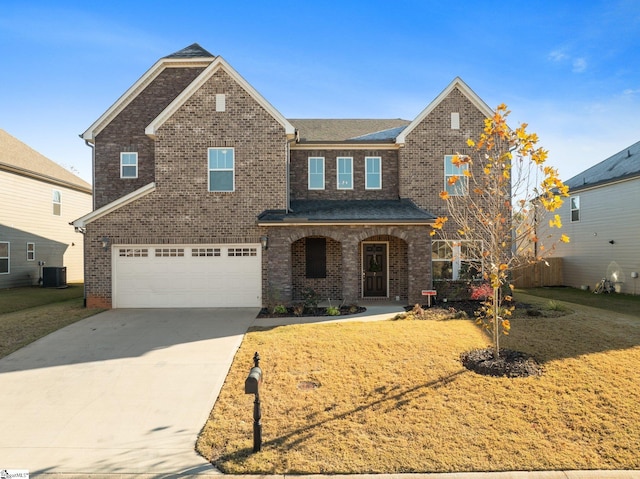 view of front of property with a front yard, covered porch, central AC unit, and a garage