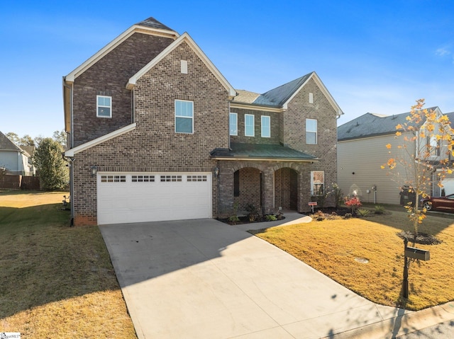 view of front of home with a garage and a front lawn