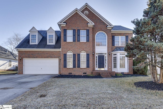 view of front of home with a front lawn and a garage