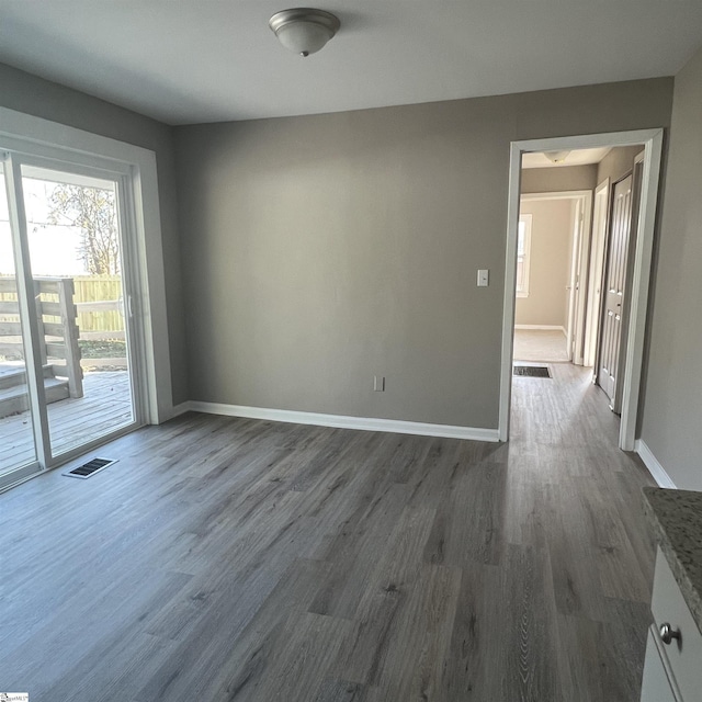 empty room featuring dark hardwood / wood-style flooring