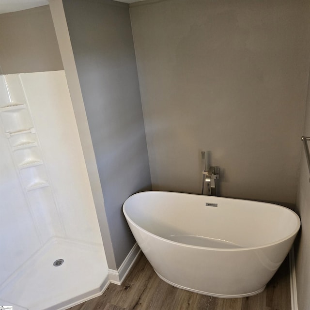 bathroom with walk in shower and hardwood / wood-style flooring