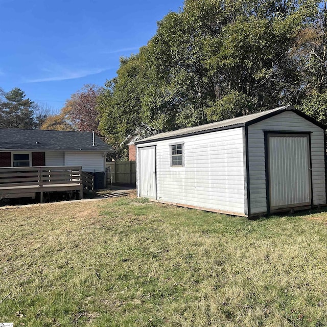 exterior space with a wooden deck and a storage shed