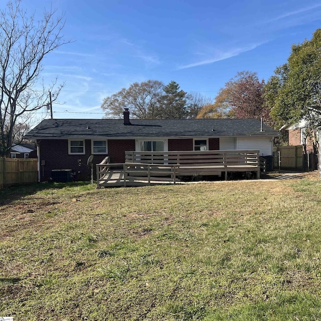 back of house with a lawn, central AC unit, and a deck