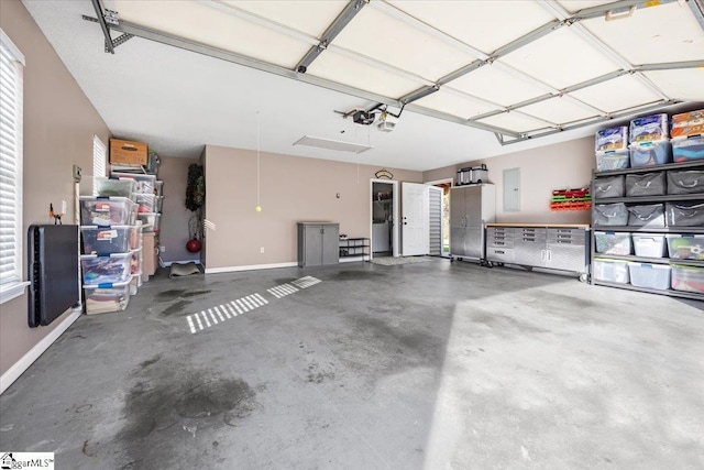 garage featuring electric panel and a garage door opener