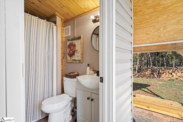 bathroom with vanity, toilet, and wood ceiling