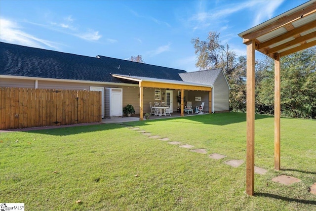 rear view of house featuring a yard and a patio area