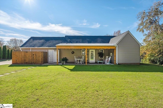 rear view of property featuring a yard and a patio