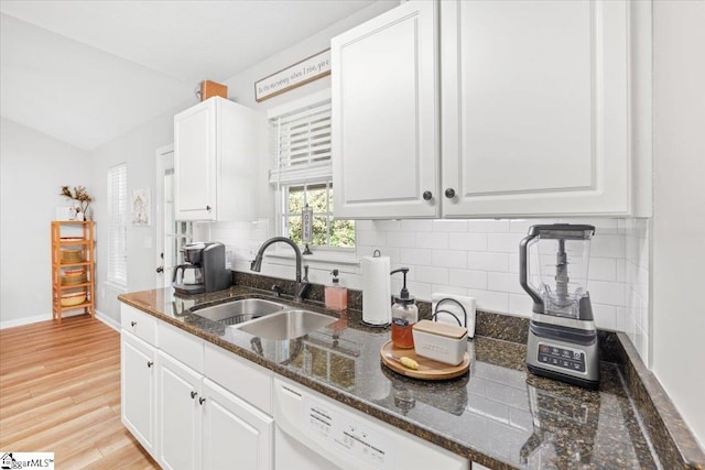 kitchen featuring white cabinets, sink, and tasteful backsplash