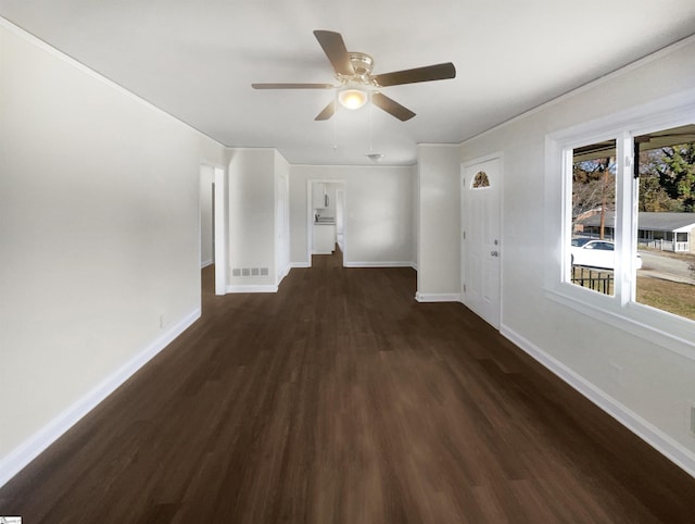 spare room with dark hardwood / wood-style floors and ceiling fan