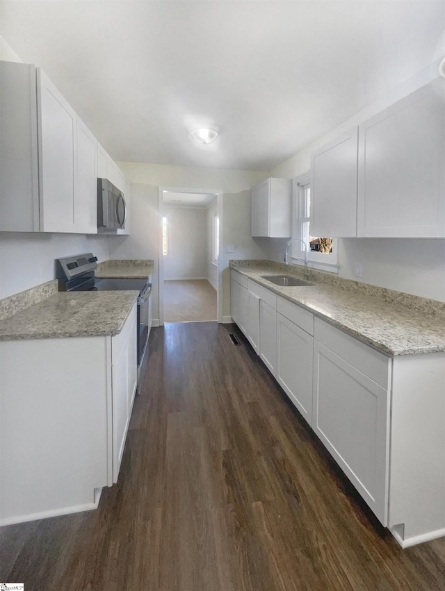 kitchen with range with electric stovetop, dark hardwood / wood-style flooring, sink, and white cabinets