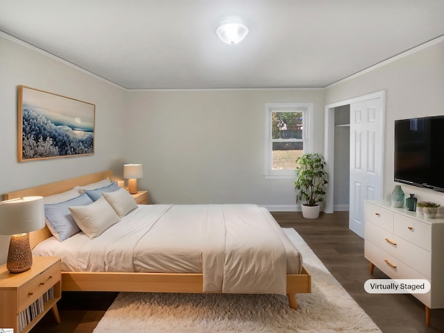 bedroom with a closet, dark hardwood / wood-style flooring, and ornamental molding