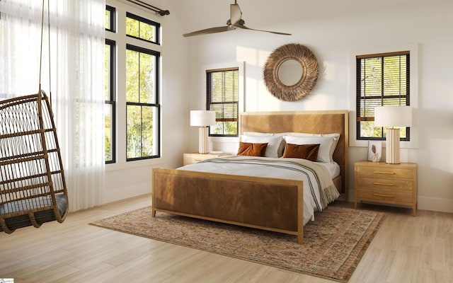 bedroom with ceiling fan, light hardwood / wood-style flooring, and multiple windows