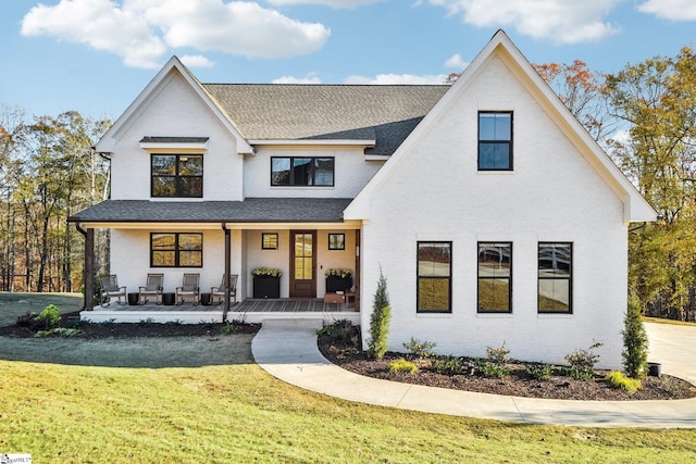 237 Rockcrest Dr, Taylors, SC 29687 - modern farmhouse with brick siding, covered porch, roof with shingles, and a front yard