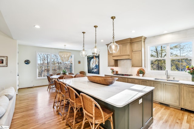 237 Rockcrest Dr, Taylors, SC 29687 - kitchen with a sink, a center island, light wood-style floors, a chandelier, and a kitchen breakfast bar