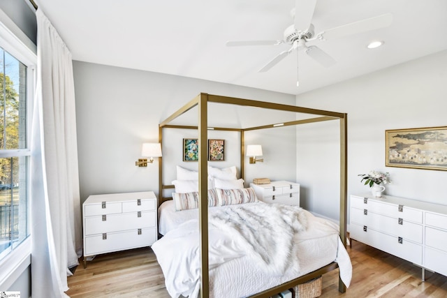 bedroom with ceiling fan and light hardwood / wood-style flooring