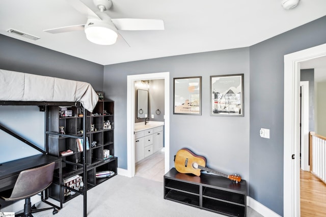 home office featuring ceiling fan, sink, and light hardwood / wood-style floors