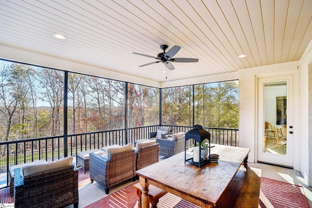 sunroom with ceiling fan and wood ceiling