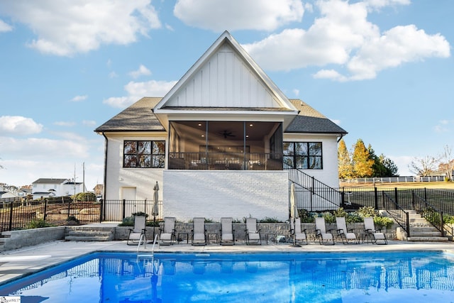 view of swimming pool featuring a sunroom, ceiling fan, and a patio