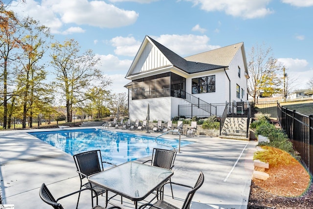 view of pool featuring a sunroom and a patio area