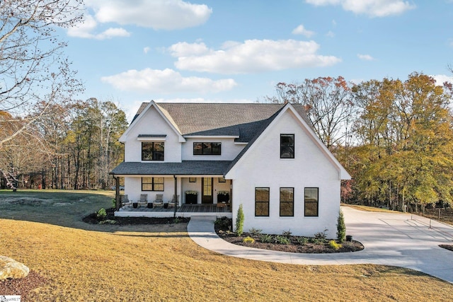 modern inspired farmhouse featuring a front yard and a porch