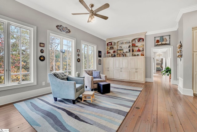 living area featuring ceiling fan, plenty of natural light, and light wood-type flooring