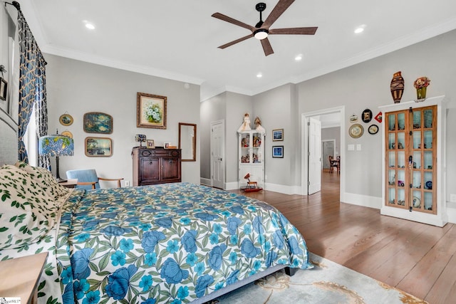 bedroom featuring dark hardwood / wood-style floors, ceiling fan, and crown molding