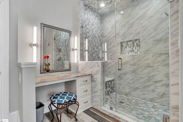 bathroom with hardwood / wood-style floors and an enclosed shower