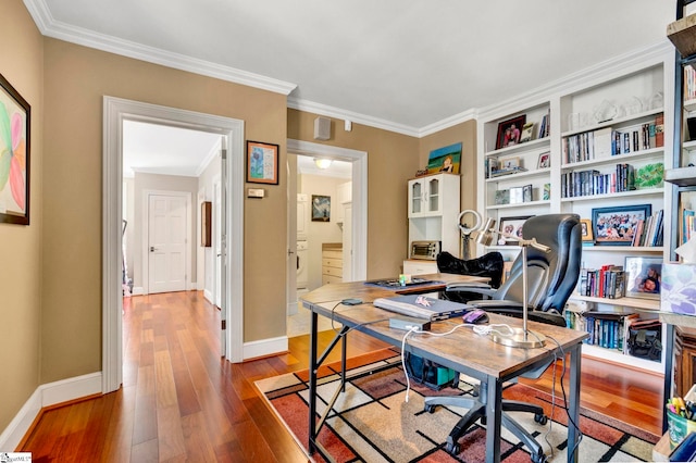 home office with wood-type flooring and crown molding