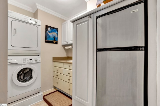 washroom featuring ornamental molding and stacked washer and clothes dryer