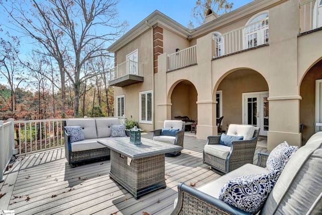 deck with french doors and an outdoor hangout area