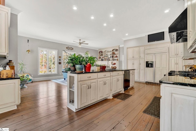 kitchen featuring dishwasher, a center island, sink, range hood, and light hardwood / wood-style floors