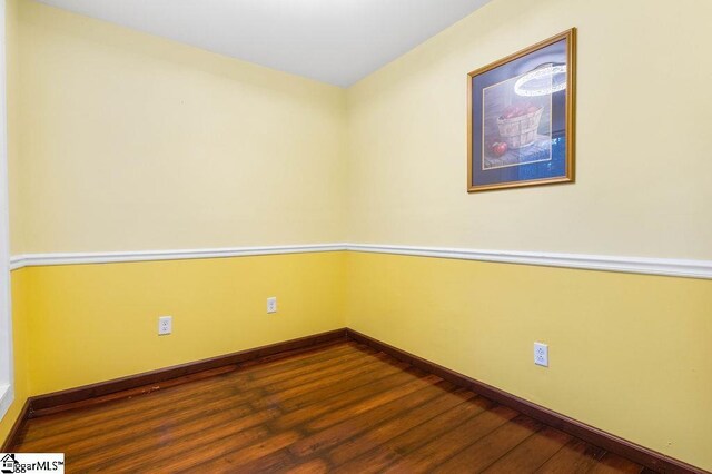 spare room with dark hardwood / wood-style floors