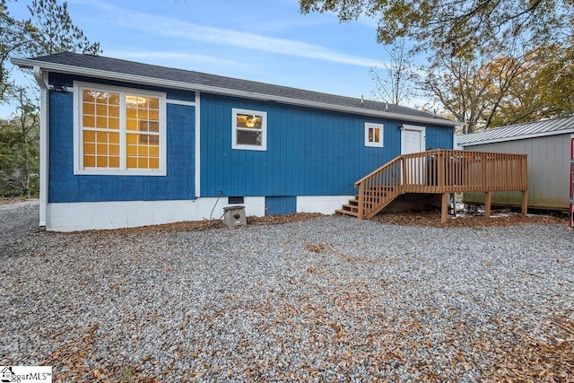 rear view of house featuring a deck